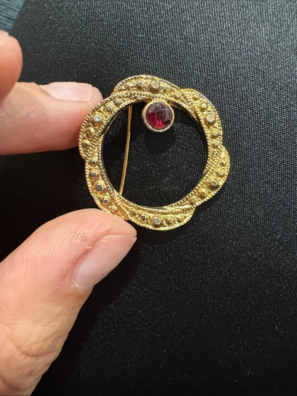 Vintage Gold Tone Circular Brooch with Red Gem Accent